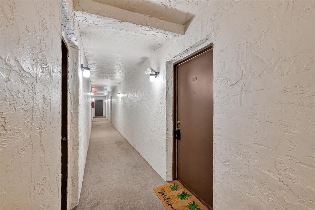 5541 Bay Boulevard, Unit 203 Port Richey, FL 34668 - Photo 3 of 30 a view of a hallway with wooden floor