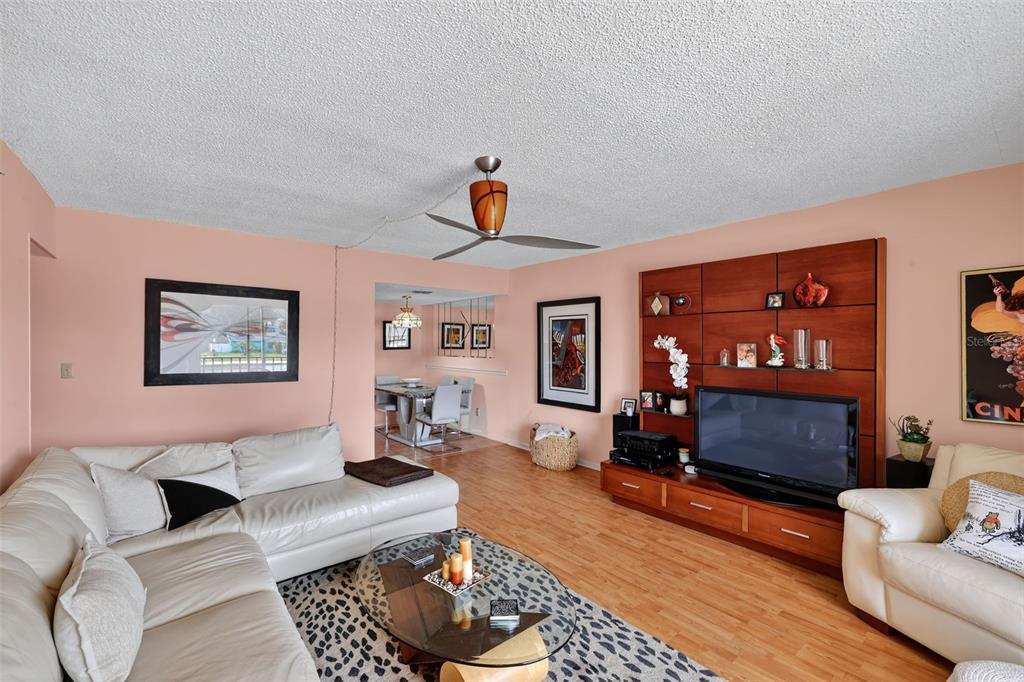 5541 Bay Boulevard, Unit 203 Port Richey, FL 34668 - Photo 4 of 30 a living room with furniture and a fireplace
