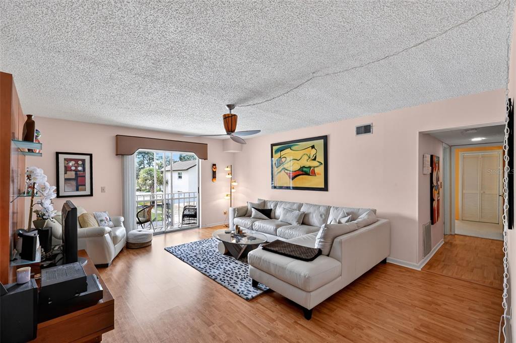 5541 Bay Boulevard, Unit 203 Port Richey, FL 34668 - Photo 7 of 30 a living room with furniture and a large window