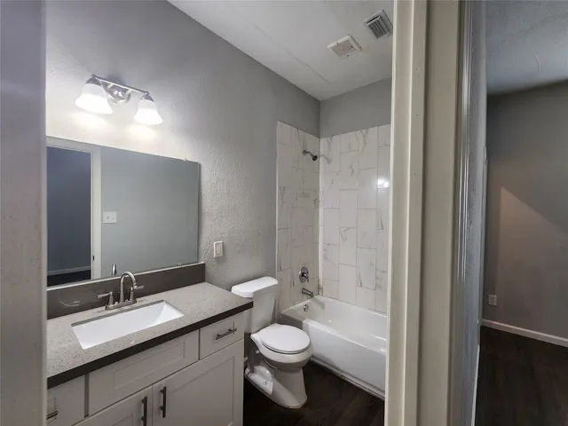 a bathroom with a double vanity sink toilet and shower