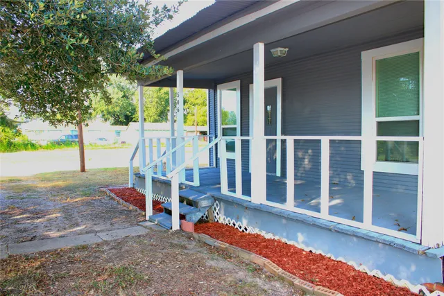 a view of a house with backyard porch and sitting area