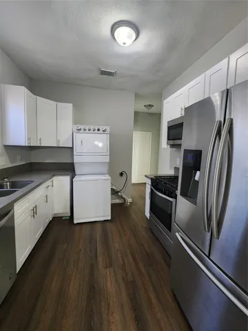 a kitchen with a refrigerator and a sink