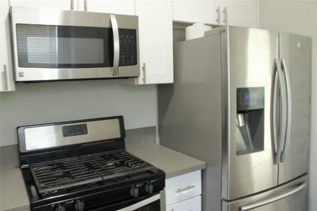 a stove top oven sitting inside of a kitchen