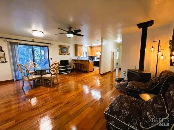 a living room with furniture a flat screen tv and floor to ceiling window