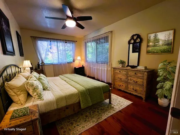 a balcony with wooden floor table and chairs