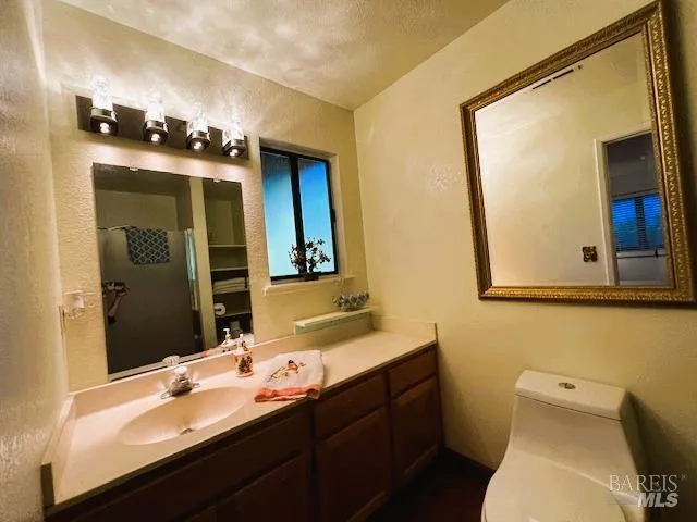 a view of a hallway with wooden floor and stairs