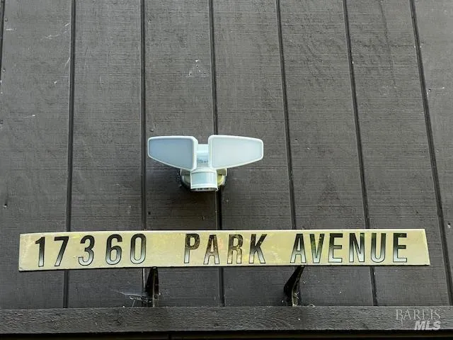 a street sign sitting on a wall in front of a bathroom