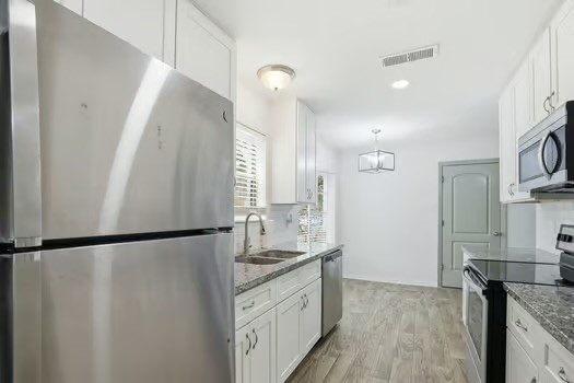 703 Reseda Drive Houston, TX 77062 - Photo 14 of 25 a bathroom with a granite countertop sink a mirror and a shower