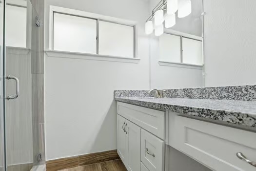 703 Reseda Drive Houston, TX 77062 - Photo 18 of 25 a bathroom with a granite countertop sink and a mirror