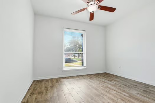 703 Reseda Drive Houston, TX 77062 - Photo 19 of 25 an empty room with a window and a ceiling fan
