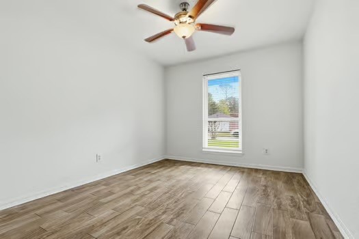 703 Reseda Drive Houston, TX 77062 - Photo 20 of 25 an empty room with wooden floor chandelier fan and windows