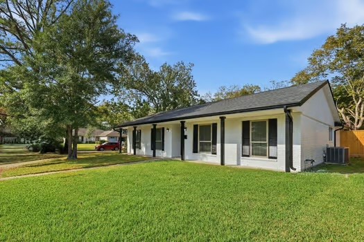 703 Reseda Drive Houston, TX 77062 - Photo 2 of 25 a front view of a house with a garden and trees