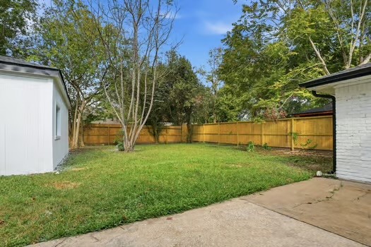 703 Reseda Drive Houston, TX 77062 - Photo 22 of 25 a view of a backyard with large trees