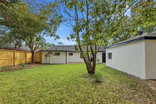 a house that has a tree in front of it