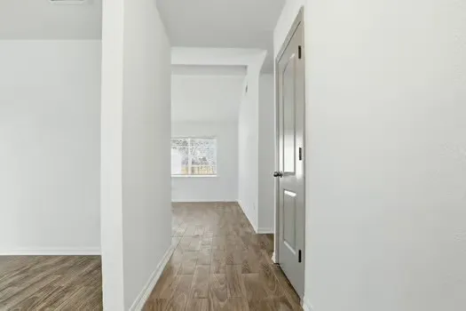 a view of hallway with wooden floor