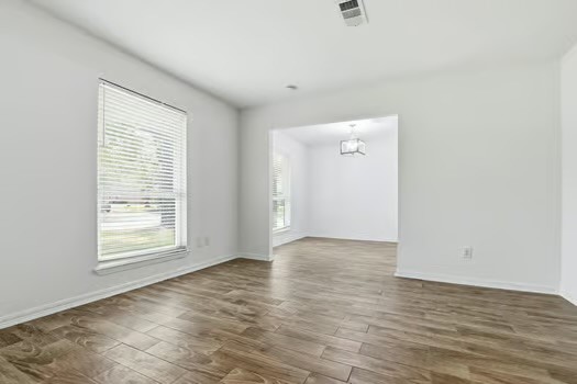 703 Reseda Drive Houston, TX 77062 - Photo 7 of 25 an empty room with wooden floor and windows