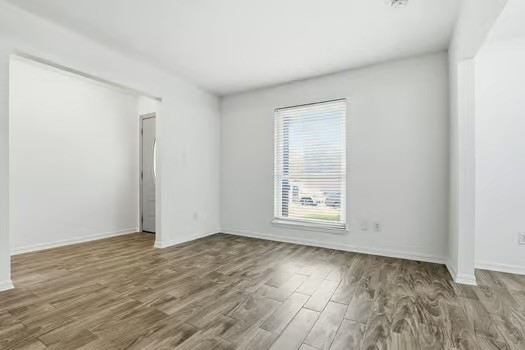 703 Reseda Drive Houston, TX 77062 - Photo 8 of 25 an empty room with wooden floor and windows