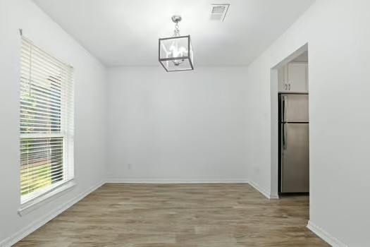 703 Reseda Drive Houston, TX 77062 - Photo 9 of 25 a view of an empty room with window and wooden floor