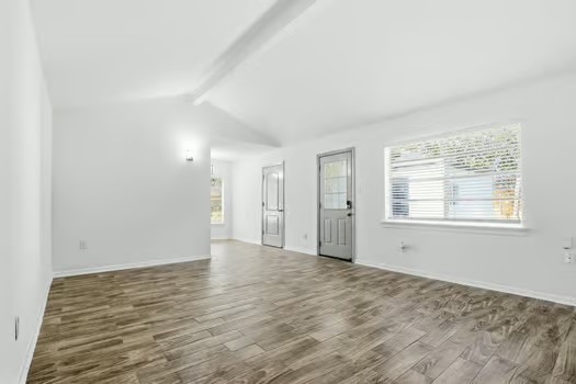 703 Reseda Drive Houston, TX 77062 - Photo 10 of 25 a view of an empty room with wooden floor and a window