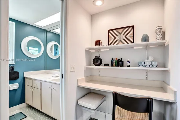 a view of a livingroom with workspace and a window