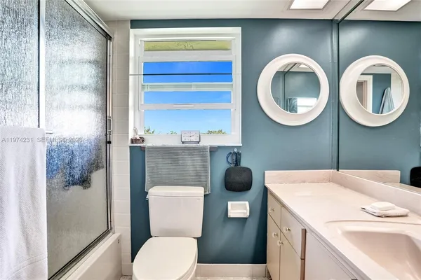 a sign that is sitting in front of a tree