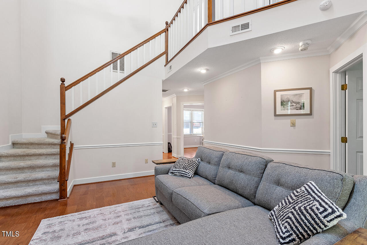 1433 Quarter Point Raleigh, NC 27615 - Photo 12 of 27 a living room with furniture and stairs