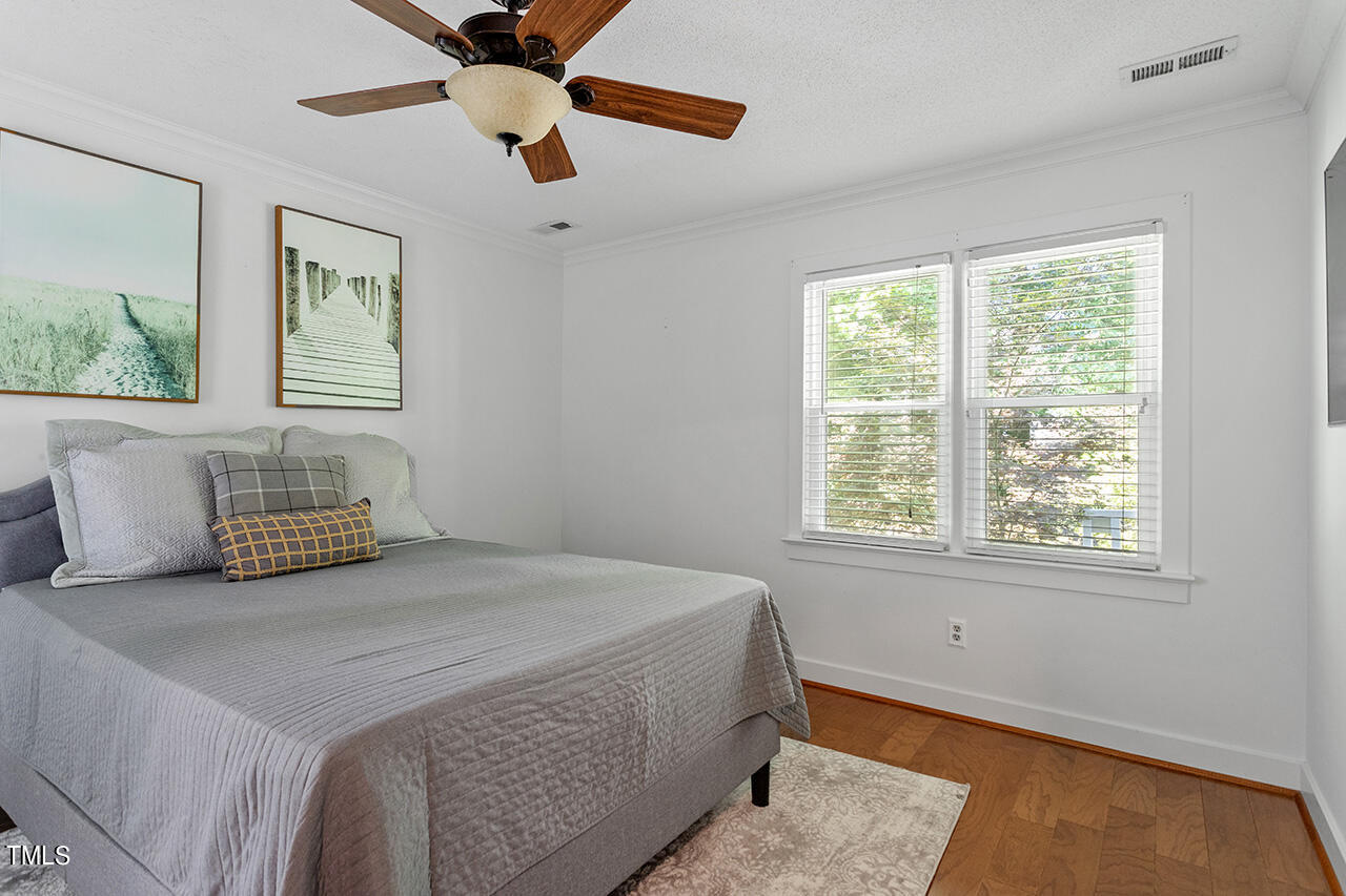 1433 Quarter Point Raleigh, NC 27615 - Photo 14 of 27 a bedroom with a bed and a window