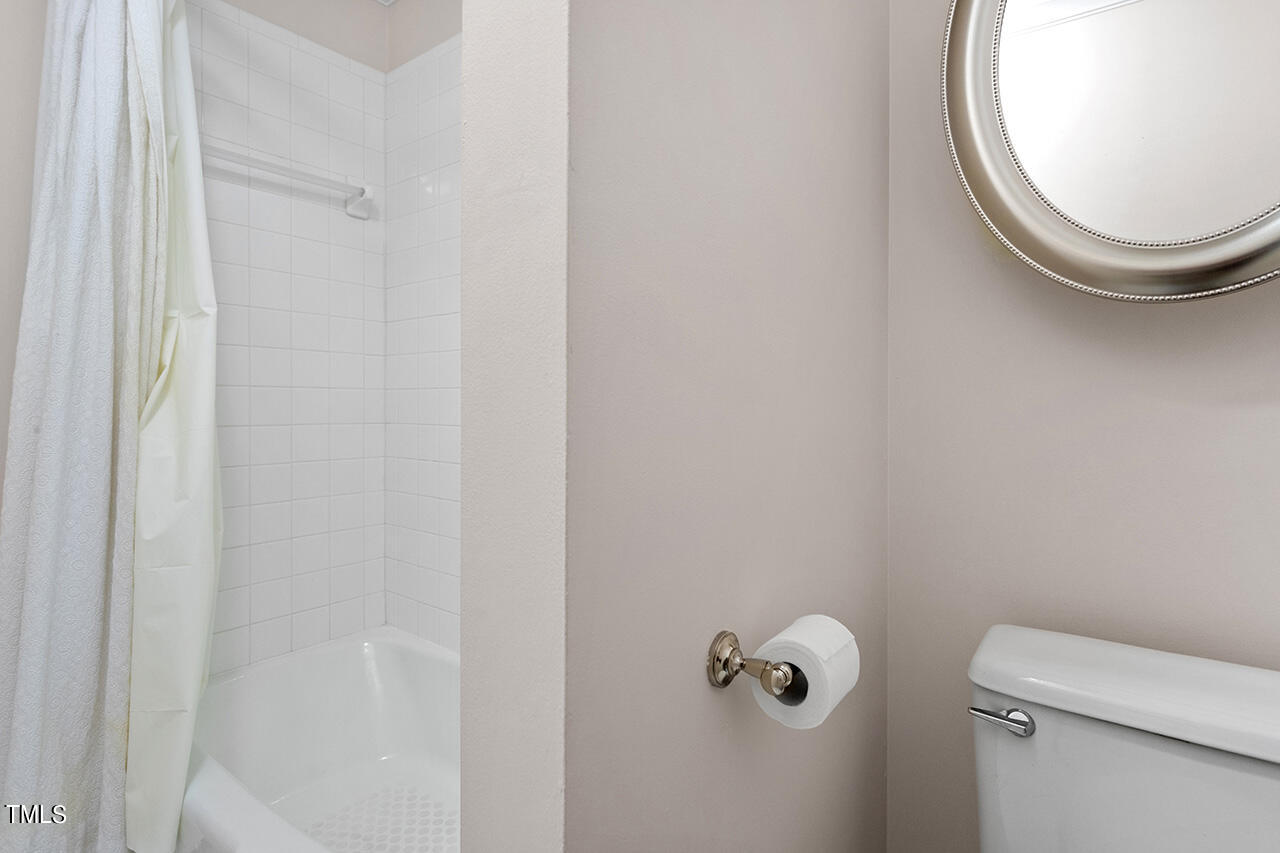 1433 Quarter Point Raleigh, NC 27615 - Photo 18 of 27 a bathroom with a toilet and a mirror
