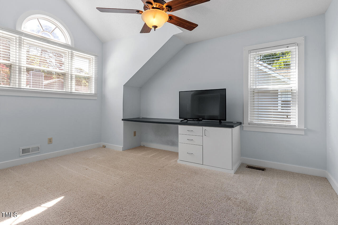 1433 Quarter Point Raleigh, NC 27615 - Photo 19 of 27 a living room with flat screen tv and a window