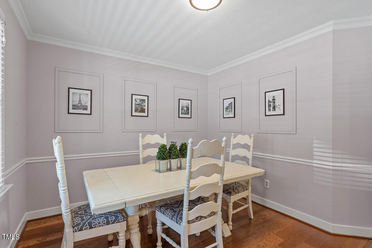 1433 Quarter Point Raleigh, NC 27615 - Photo 3 of 27 a view of a dining room with furniture and wooden floor