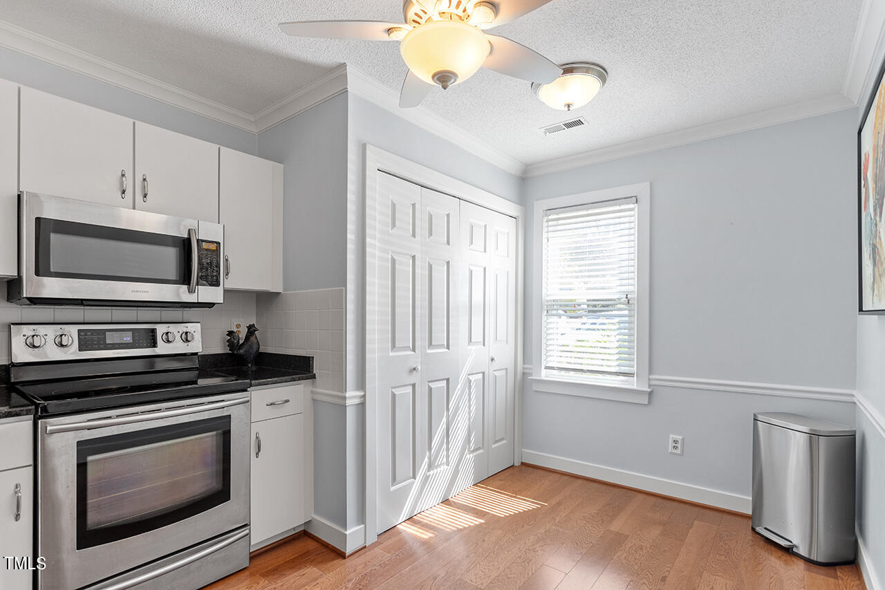 1433 Quarter Point Raleigh, NC 27615 - Photo 7 of 27 a kitchen with a stove and a microwave