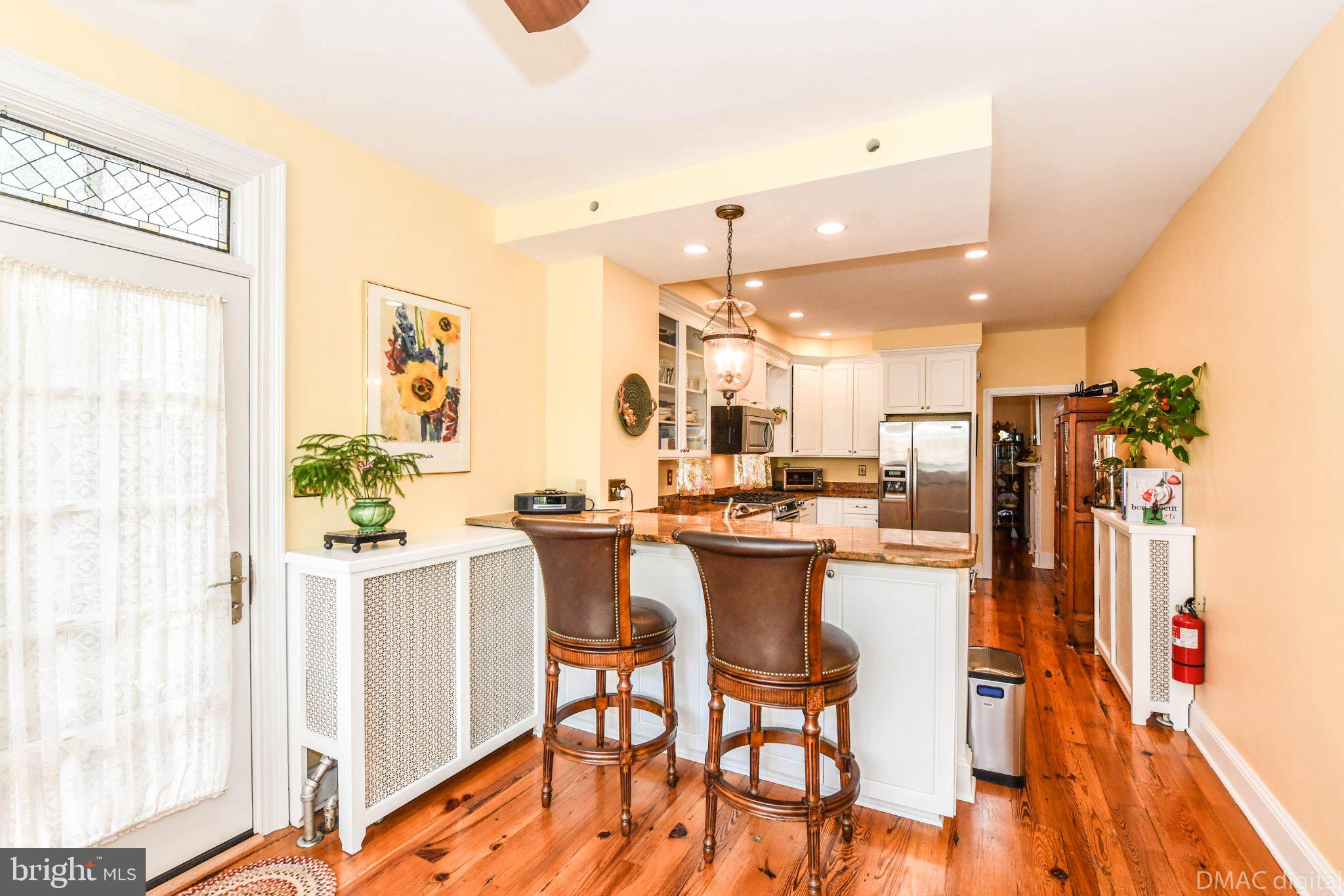 106 West 3rd Street Frederick, MD 21701 - Photo 12 of 46 a dining hall with stainless steel appliances kitchen island granite countertop a table and chairs