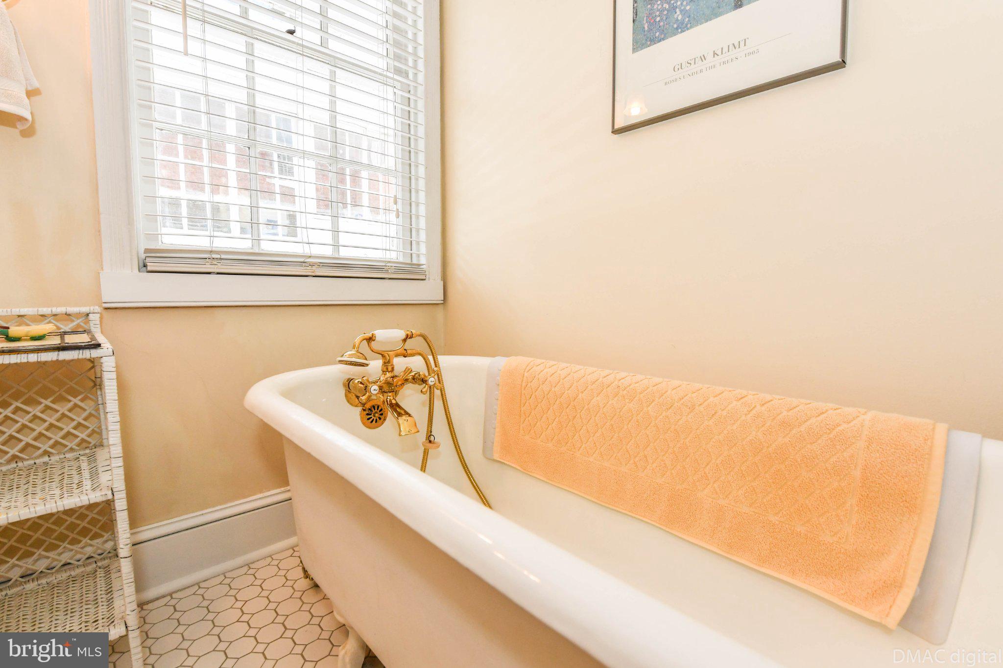 106 West 3rd Street Frederick, MD 21701 - Photo 16 of 46 a bathroom with a bathtub and a sink