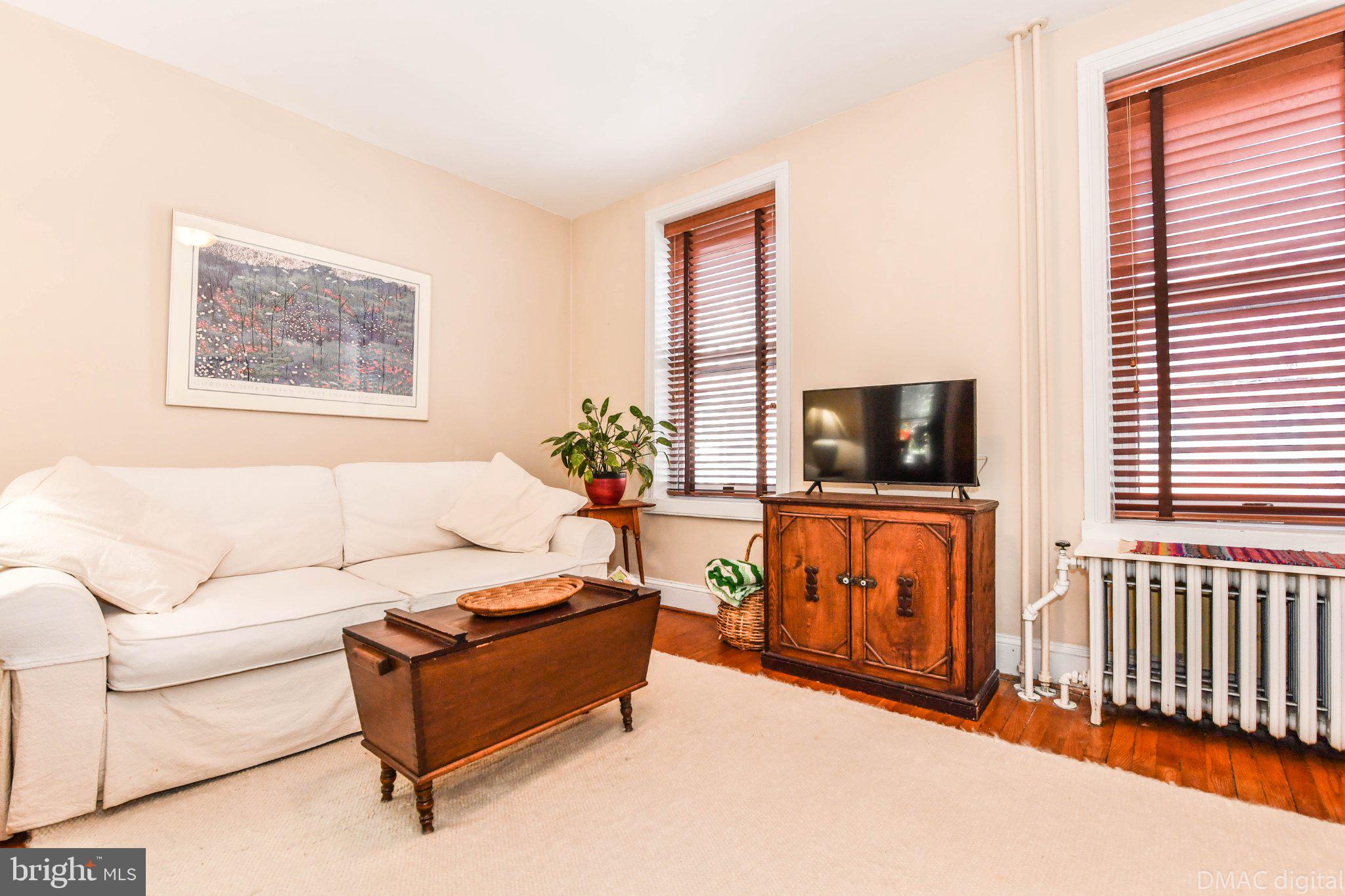 106 West 3rd Street Frederick, MD 21701 - Photo 23 of 46 a living room with furniture and a flat screen tv