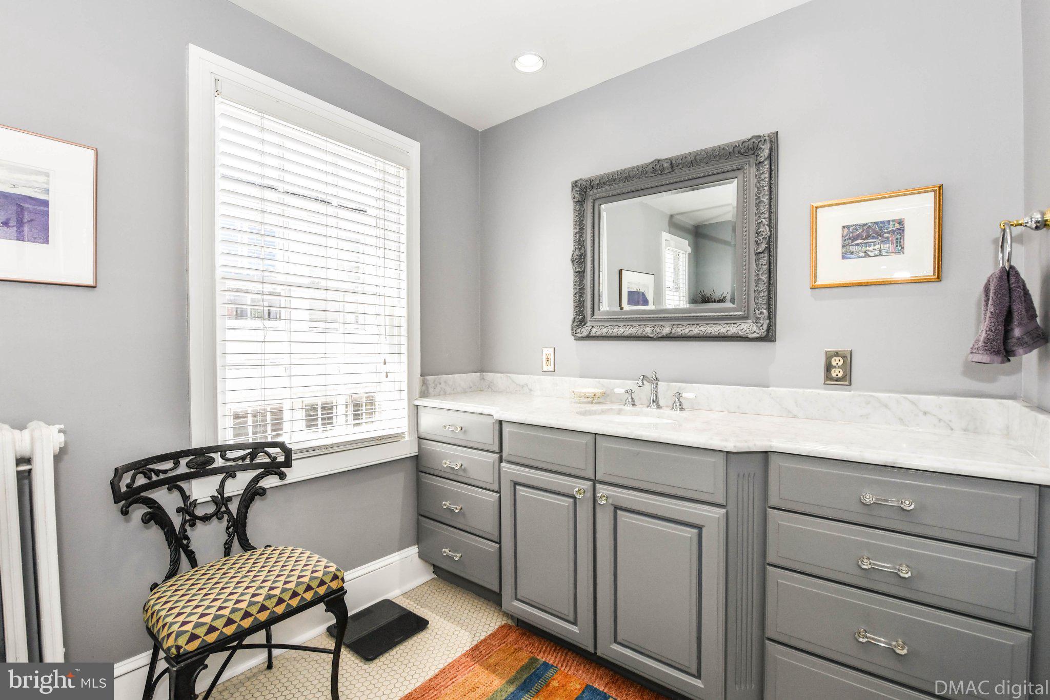 106 West 3rd Street Frederick, MD 21701 - Photo 28 of 46 a spacious bathroom with a granite countertop sink mirror and a bathtub