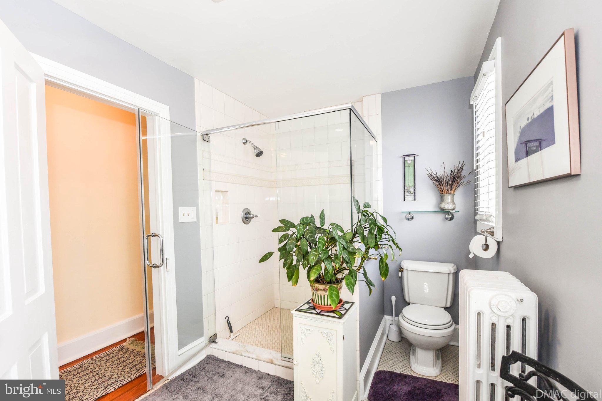106 West 3rd Street Frederick, MD 21701 - Photo 29 of 46 a bathroom with a toilet a sink and a shower