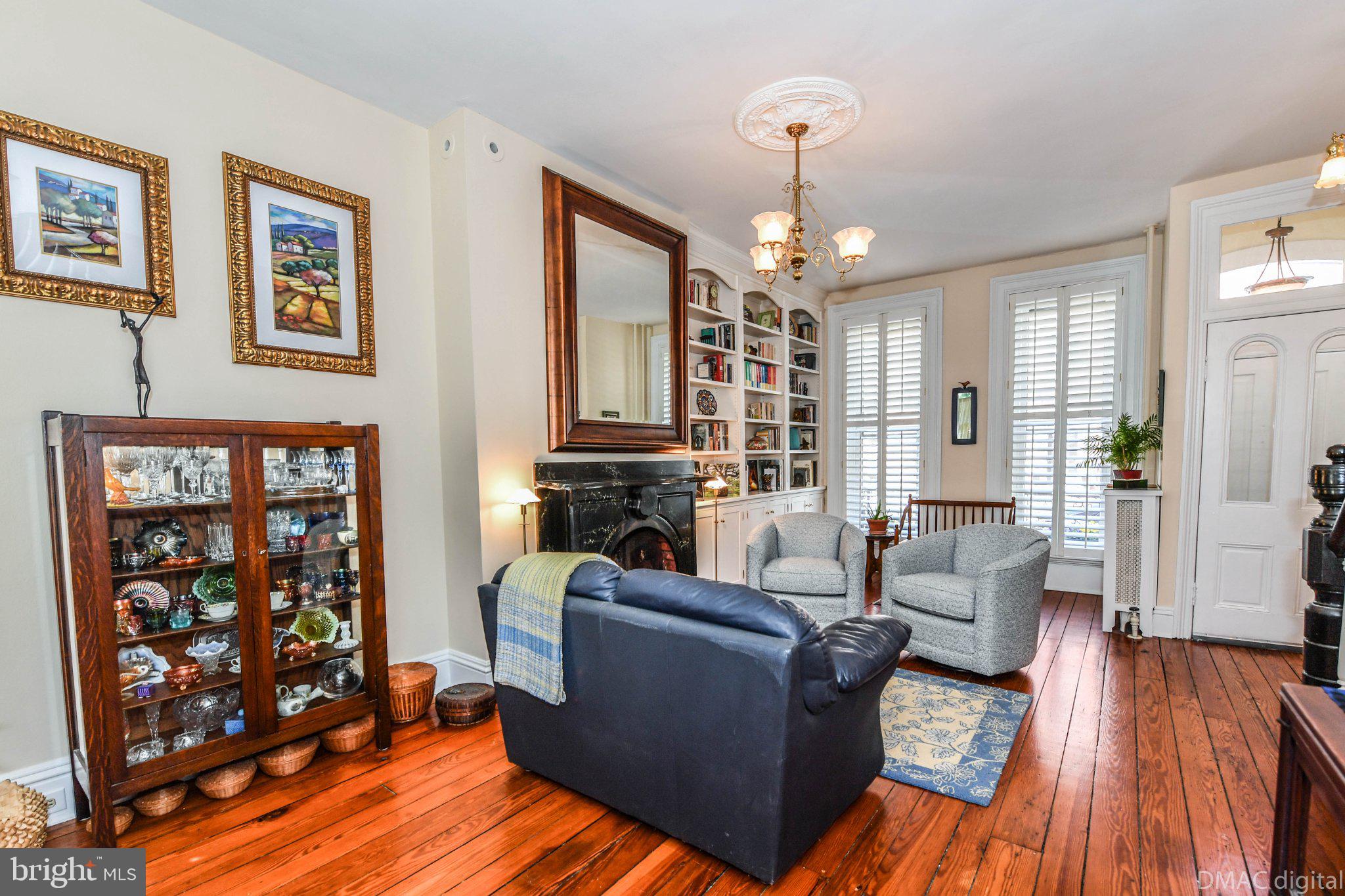 106 West 3rd Street Frederick, MD 21701 - Photo 4 of 46 a living room with furniture a bookshelf and a wooden floor