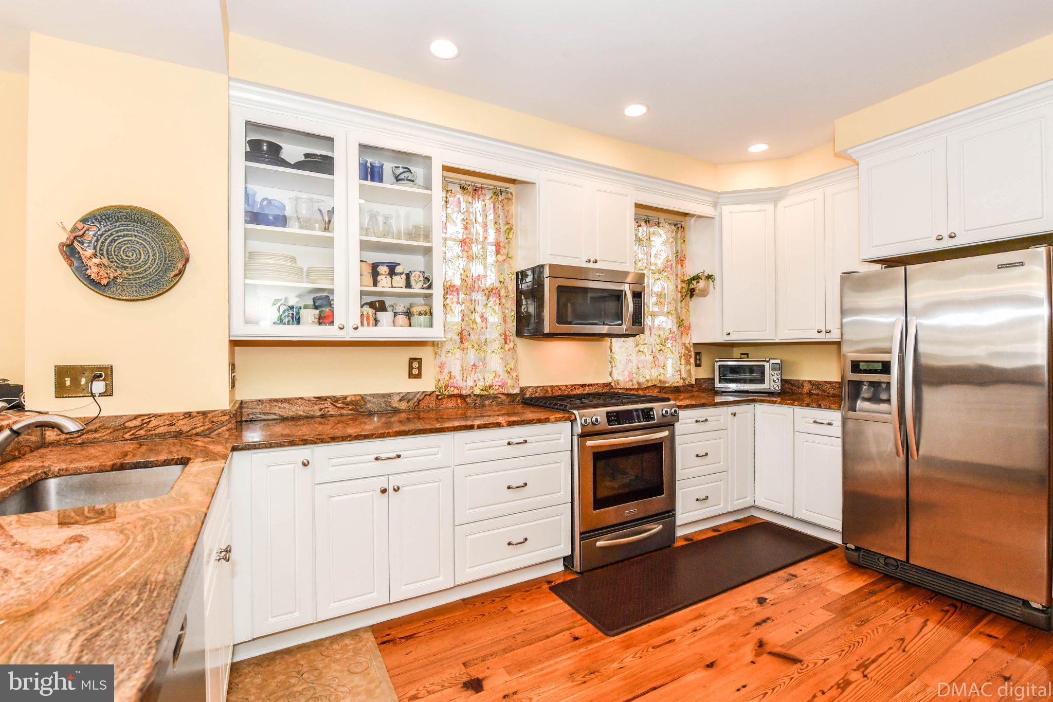 106 West 3rd Street Frederick, MD 21701 - Photo 9 of 46 a kitchen with stainless steel appliances granite countertop a stove a sink and a refrigerator