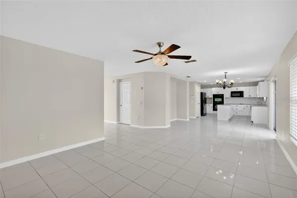 a view of a livingroom with furniture and a ceiling fan