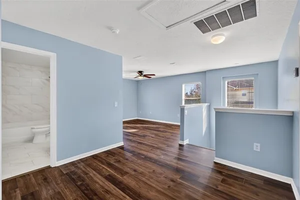 a view of empty room with wooden floor