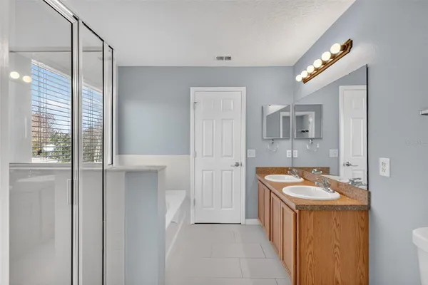 a bathroom with a sink a mirror and a shower