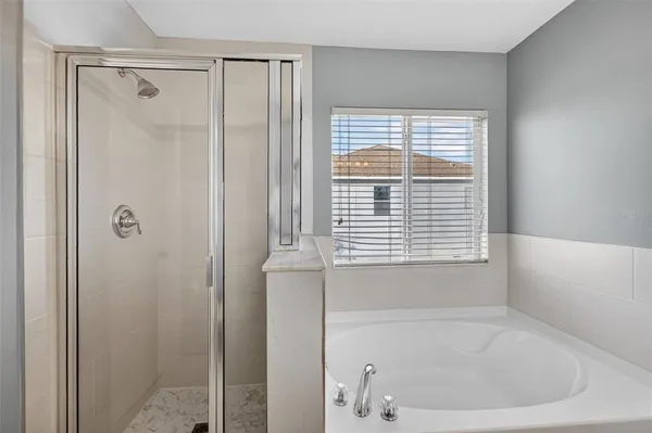 a white bath tub sitting next to a window