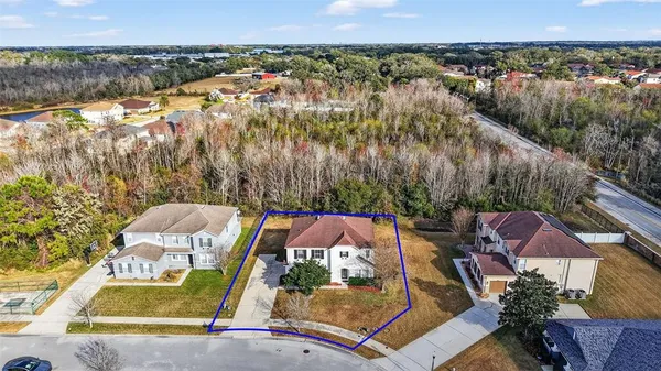an aerial view of residential houses with outdoor space and swimming pool