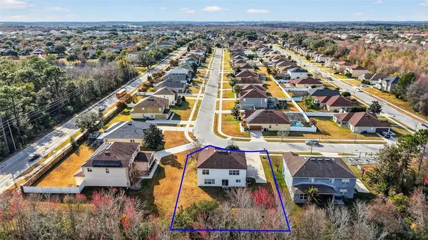 an aerial view of residential houses with outdoor space