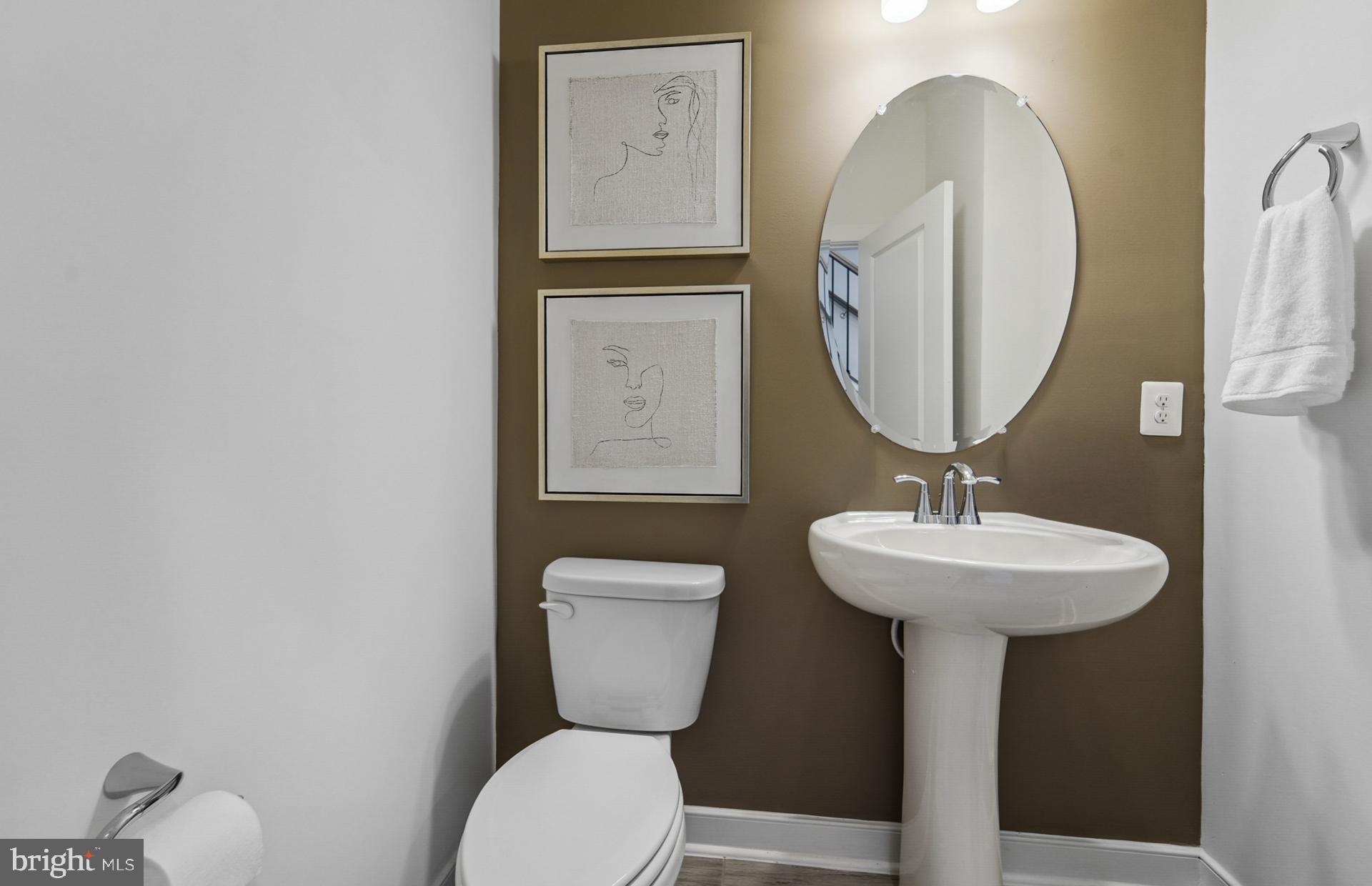 1306 Bracken Lane Laurel, MD 20724 - Photo 5 of 44 a bathroom with a toilet a sink and mirror