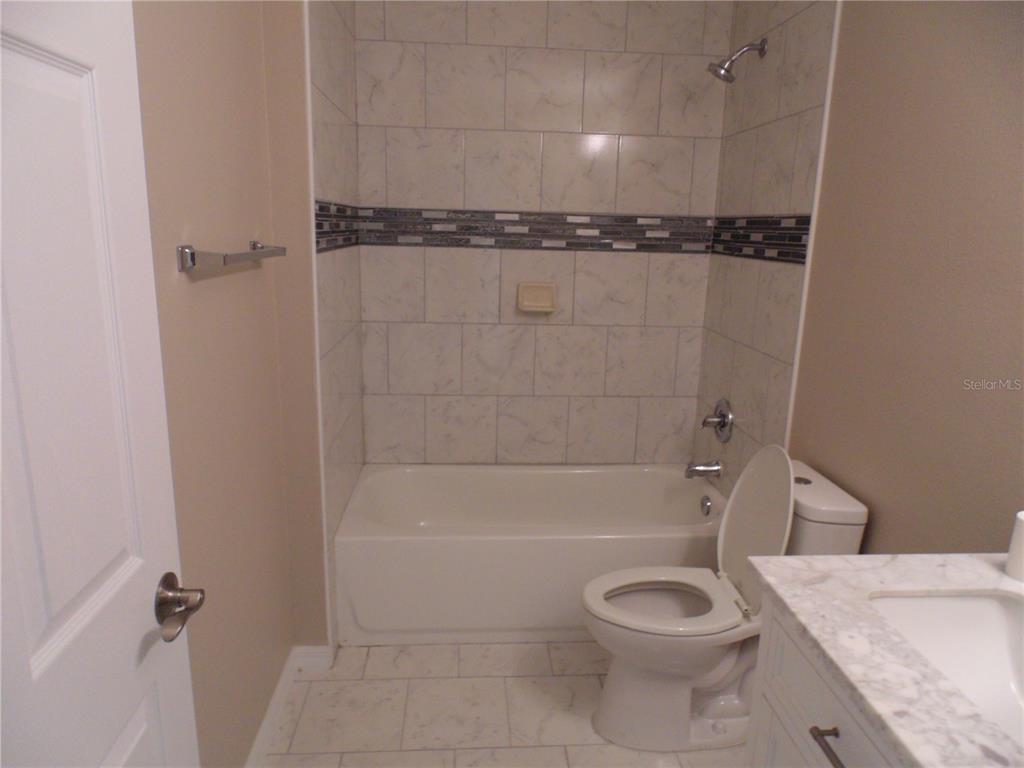 10856 Southwest 79th Avenue Ocala, FL 34476 - Photo 16 of 33 a bathroom with a toilet and a shower