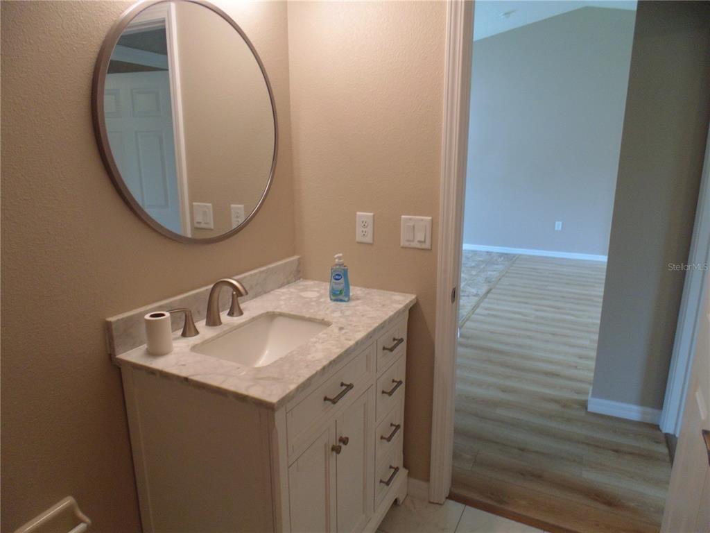 10856 Southwest 79th Avenue Ocala, FL 34476 - Photo 17 of 33 a bathroom with a sink and a mirror