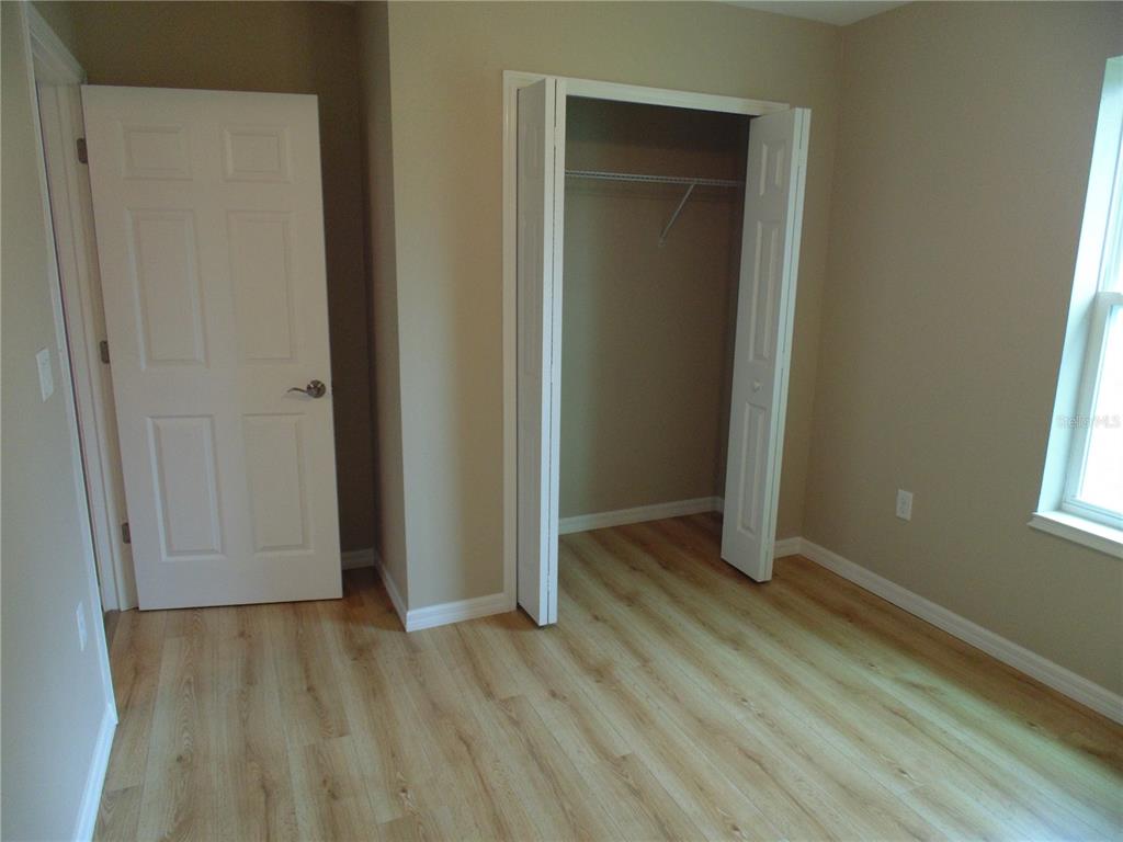 10856 Southwest 79th Avenue Ocala, FL 34476 - Photo 18 of 33 an empty room with wooden floor and closet area