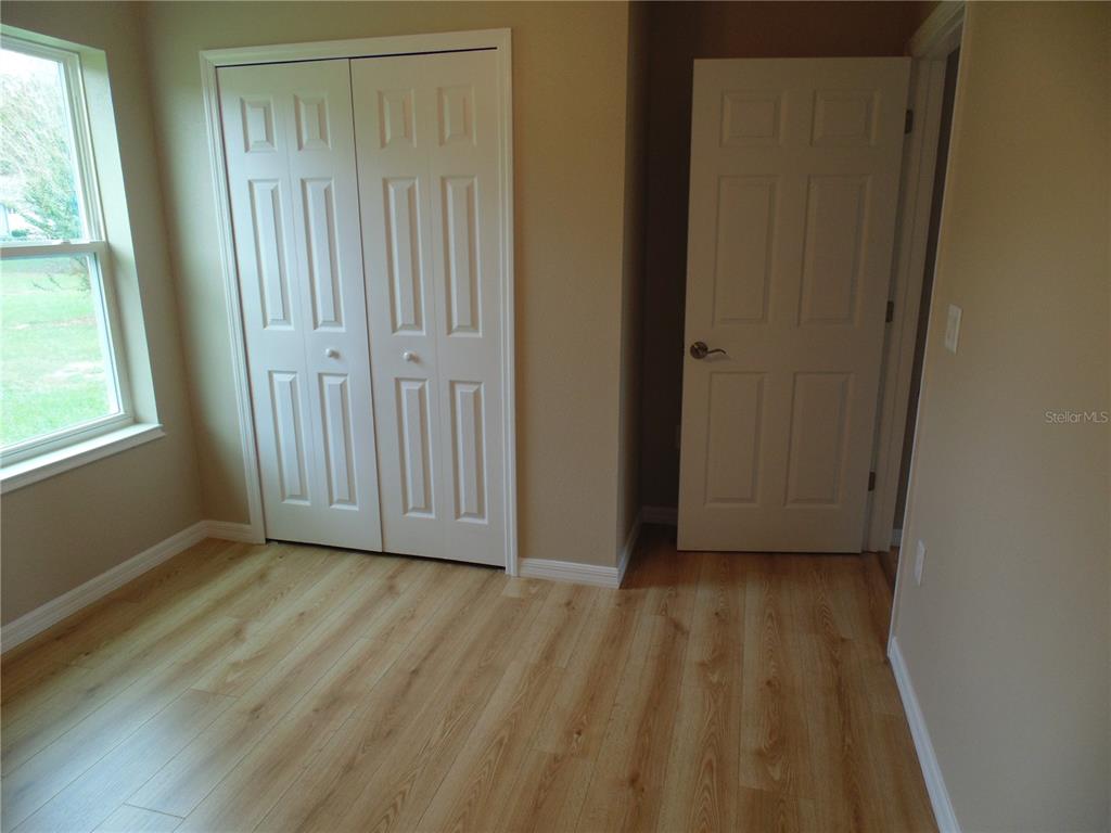 10856 Southwest 79th Avenue Ocala, FL 34476 - Photo 19 of 33 a view of a room with wooden floor and a window