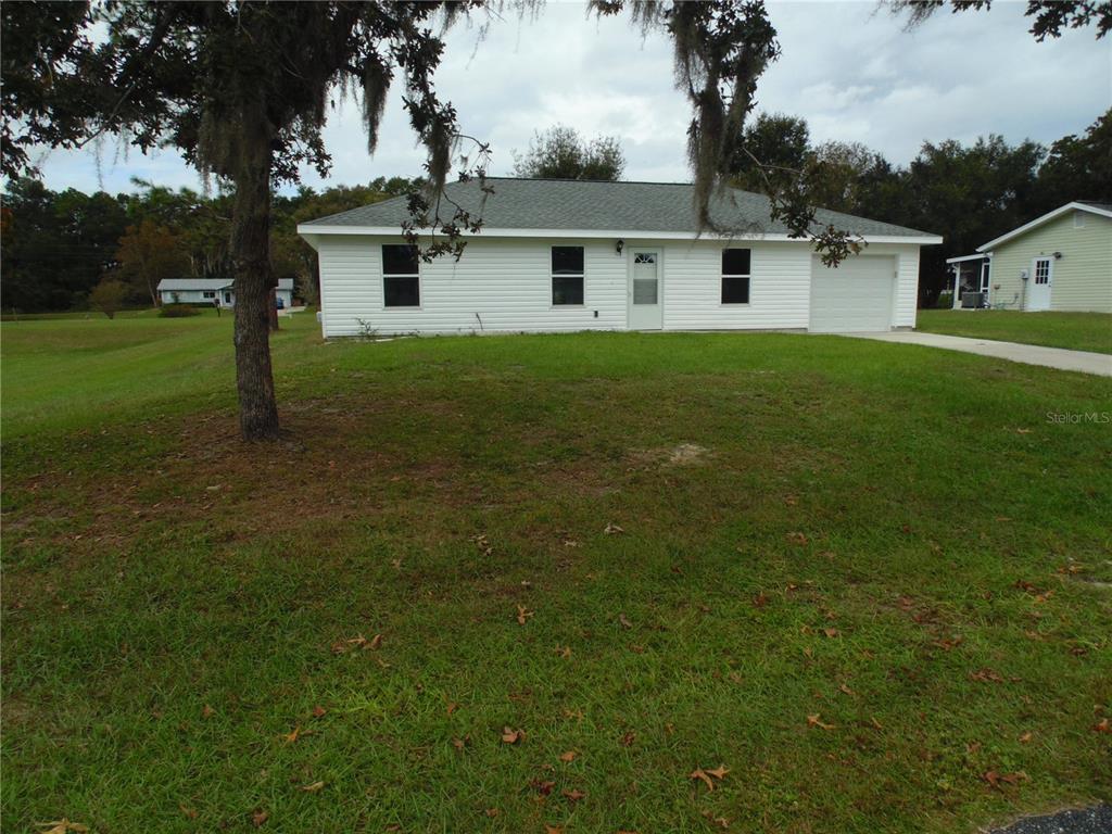 10856 Southwest 79th Avenue Ocala, FL 34476 - Photo 26 of 33 a front view of house with yard and trees